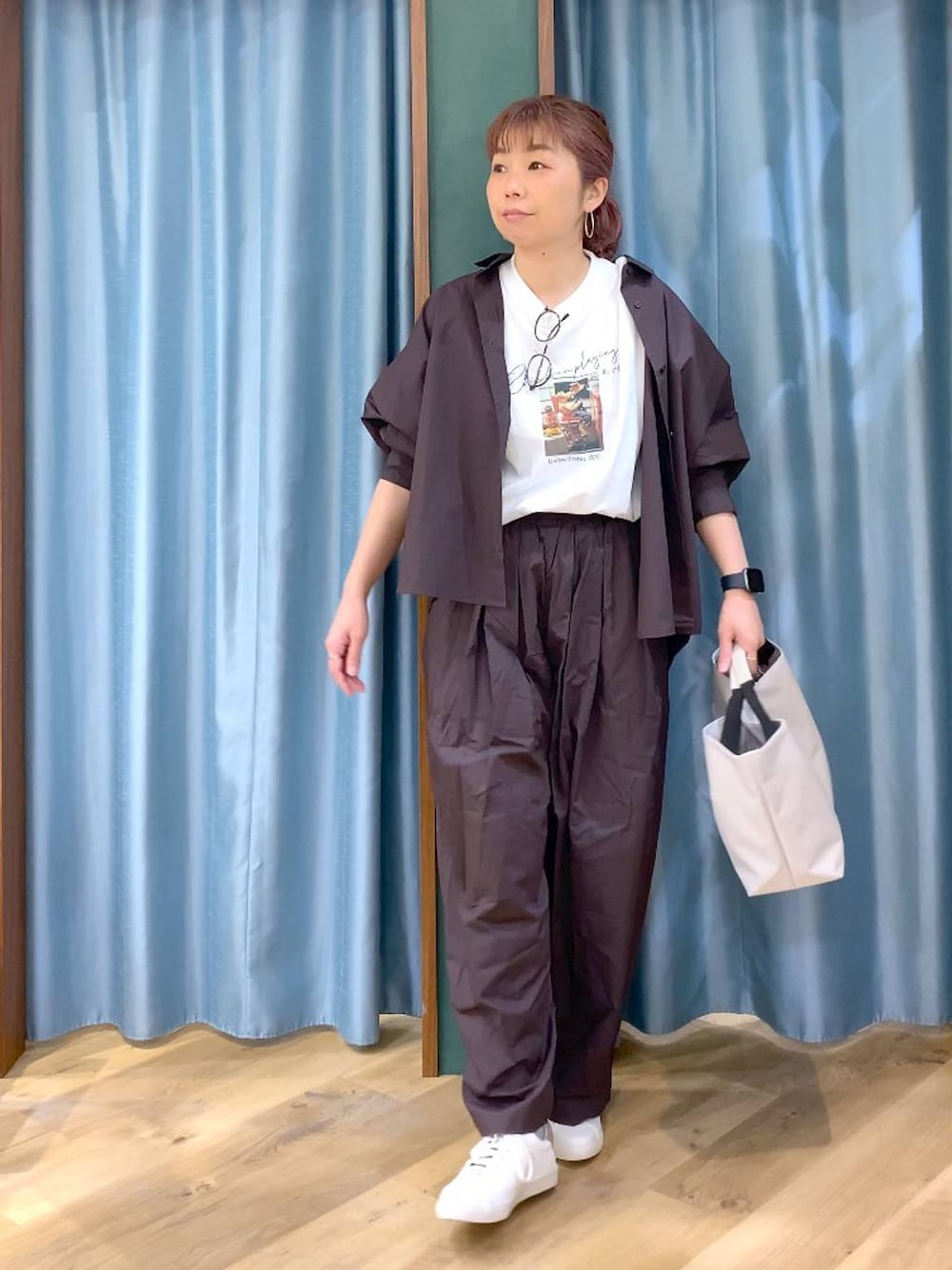 ブラウン系のその他パンツ、ブラウン系のスニーカー、ホワイト系のトートバッグを着用したレディースの春コーディネートの1枚目の写真