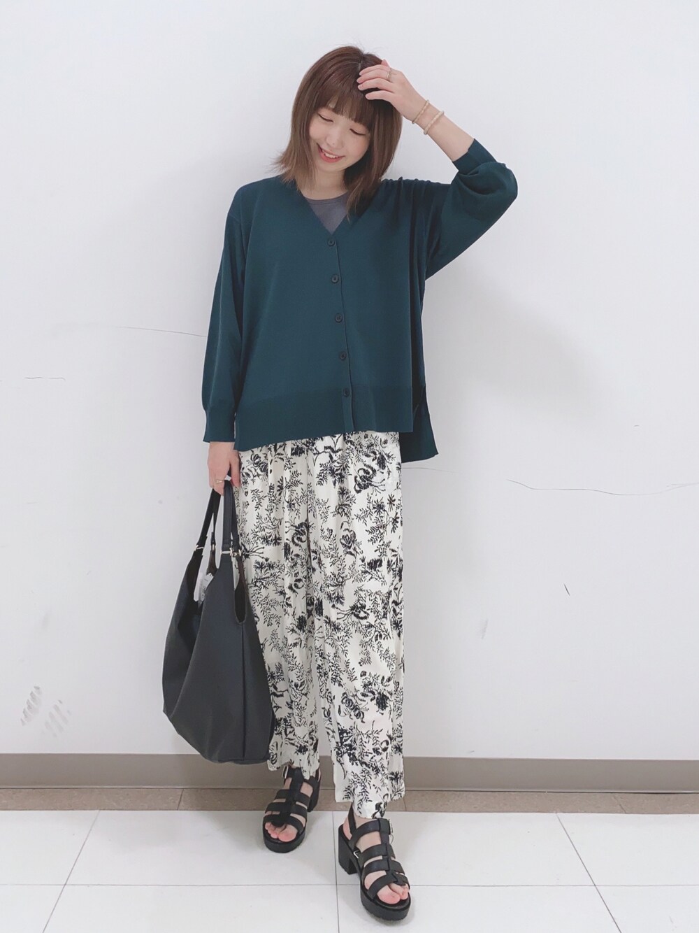 グリーン系のカーディガン/ボレロ、グレー系のタンクトップ、ベージュ系のその他パンツを着用したレディースの春コーディネートの1枚目の写真