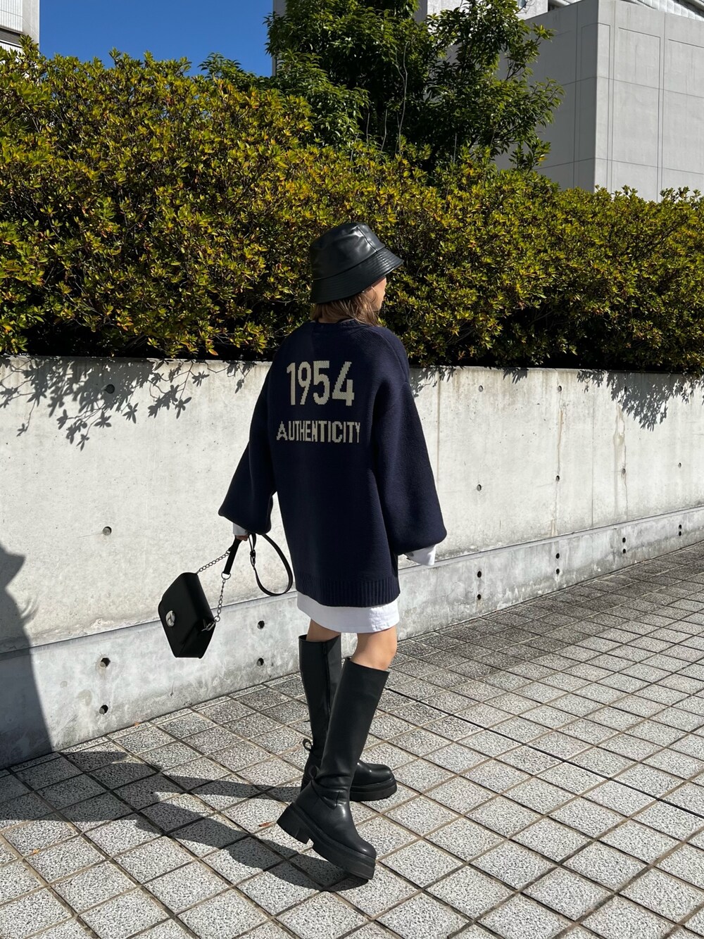 ブラック系のブーツ、ブラック系のショルダーバッグ、ホワイト系のTシャツ/カットソーを着用したレディースの秋コーディネートの1枚目の写真