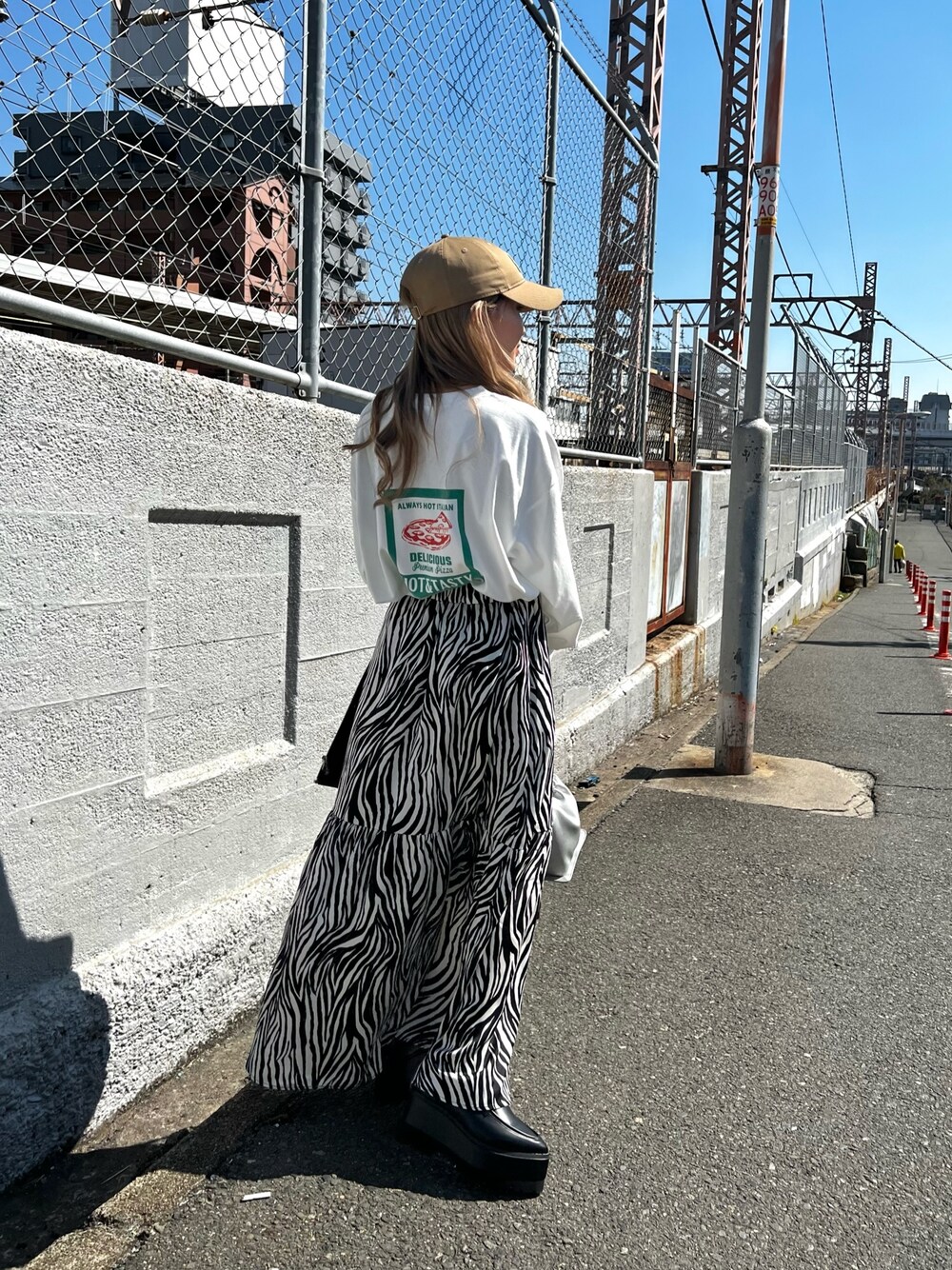 ブラック系のローファー、ホワイト系のTシャツ/カットソー、ホワイト系のスカートを着用したレディースの春コーディネートの1枚目の写真