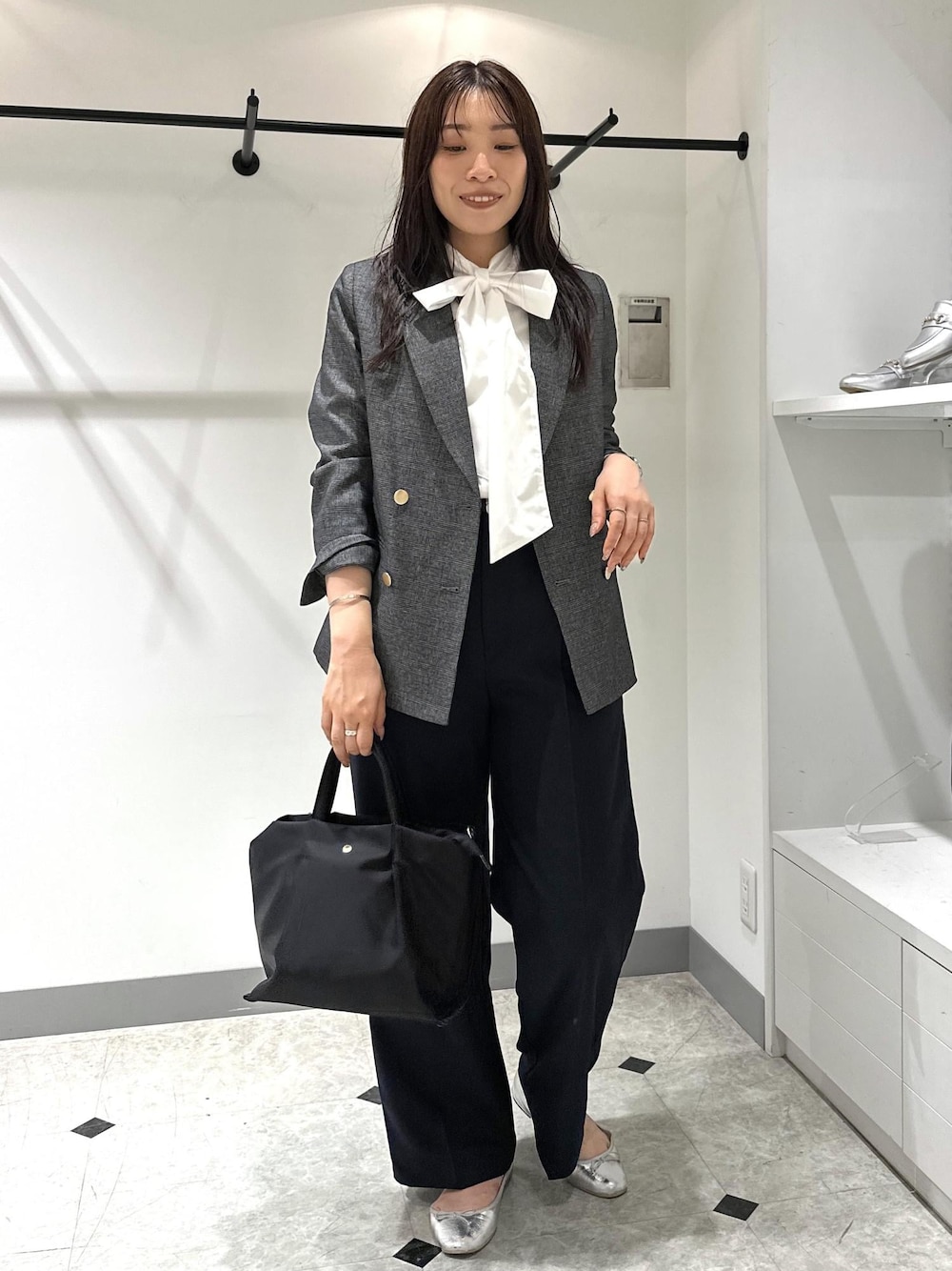 シルバー系のバレエシューズ、ブルー系のシャツ/ブラウス、ブラック系のショルダーバッグを着用したレディースの夏コーディネートの1枚目の写真
