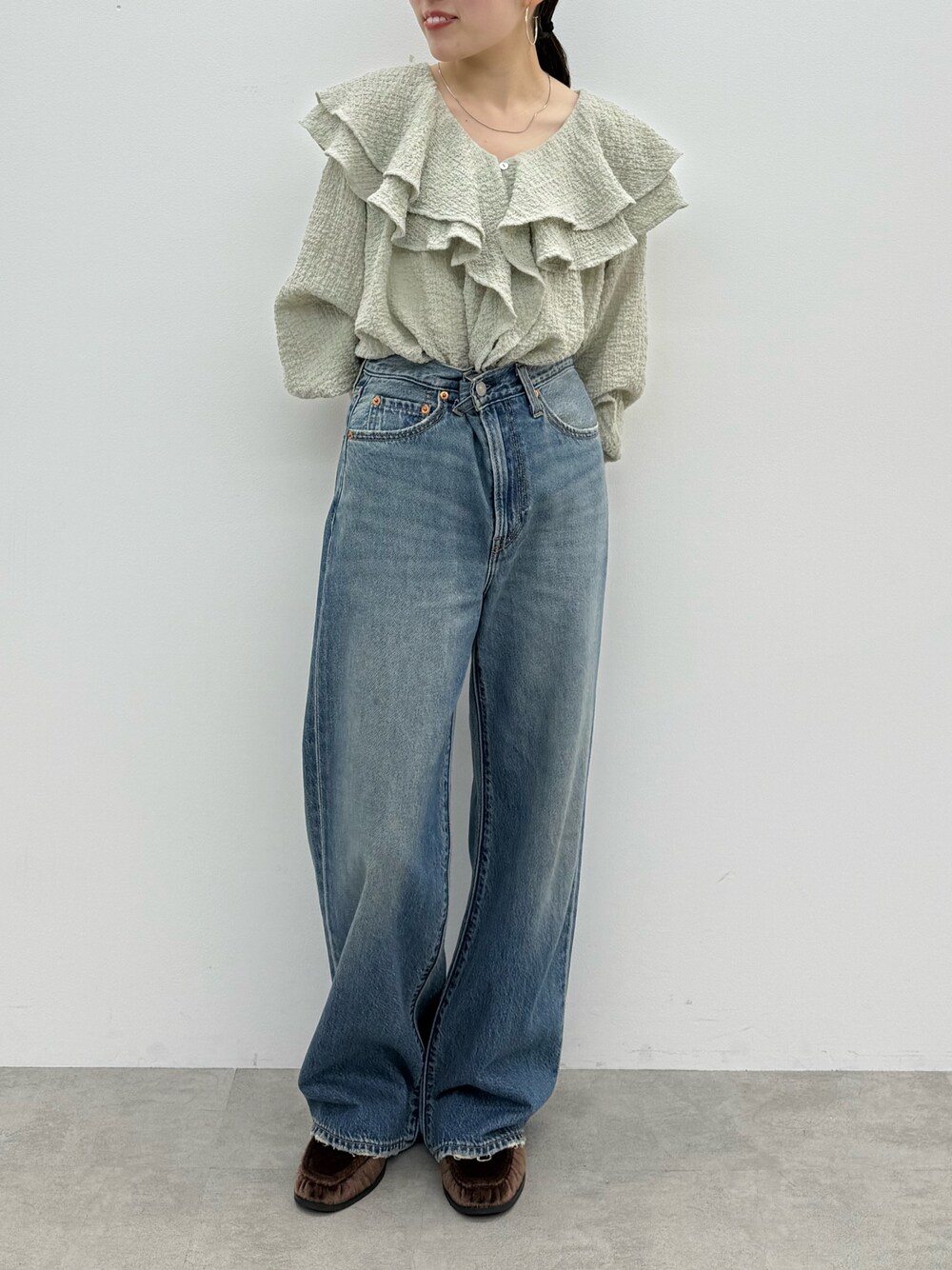 ブルー系のデニムパンツ、ブラウン系のローファー、ブルー系のシャツ/ブラウスを着用したレディースの秋コーディネートの1枚目の写真