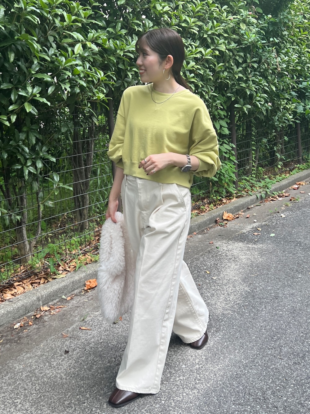 ホワイト系のデニムパンツ、ブラウン系のブーツ、グリーン系のスウェットを着用したレディースの秋コーディネートの1枚目の写真