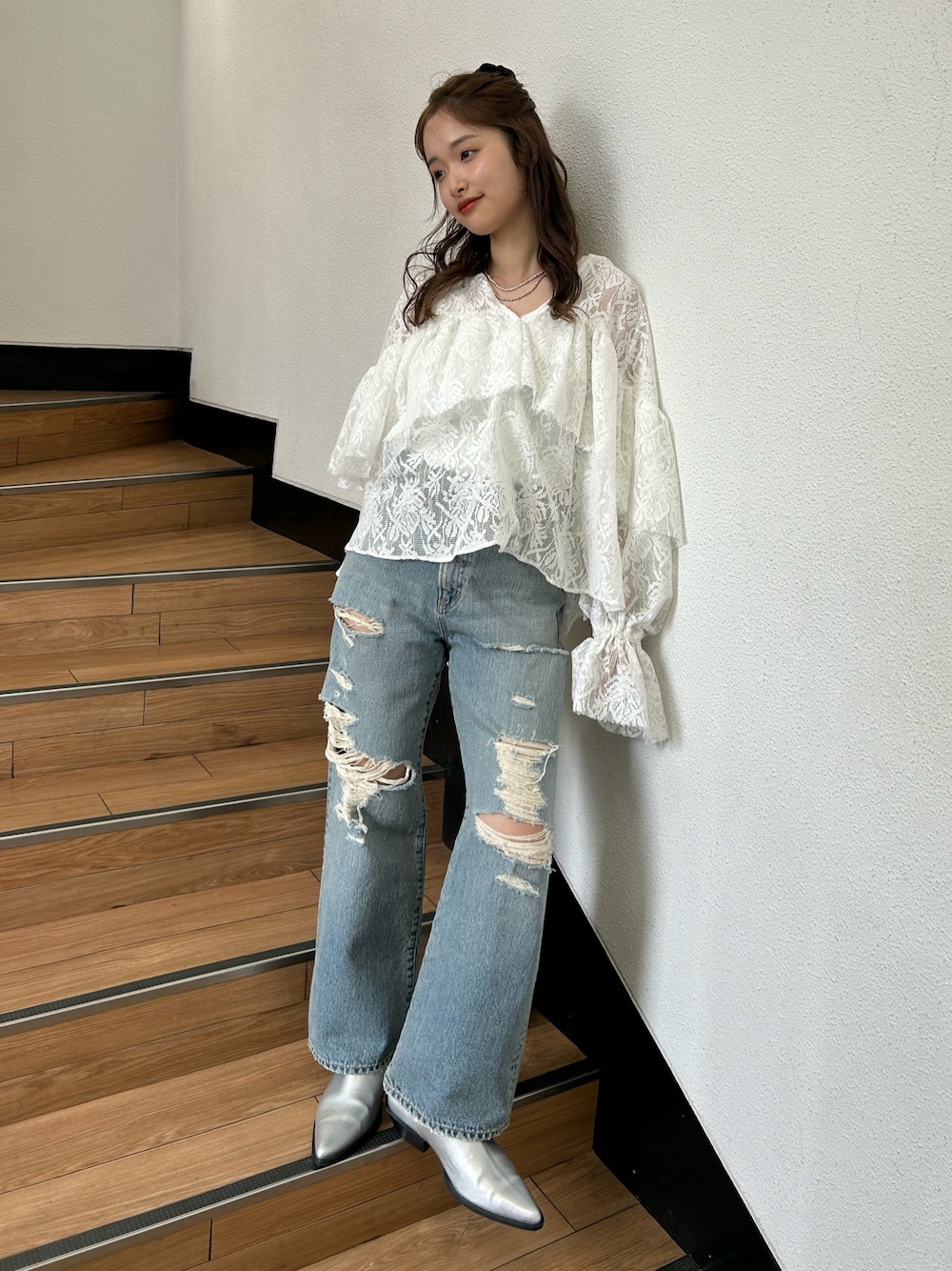 ブルー系のデニムパンツ、シルバー系のブーツ、ホワイト系のシャツ/ブラウスを着用したレディースの春コーディネートの1枚目の写真