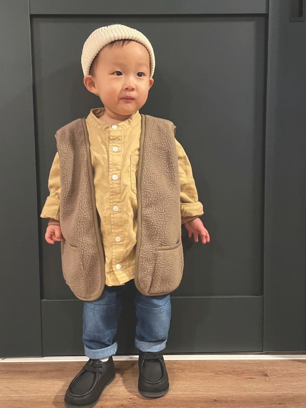 イエロー系のシャツ/ブラウス、グリーン系のその他アウター、ブルー系のデニムパンツを着用したキッズの冬コーディネートの1枚目の写真