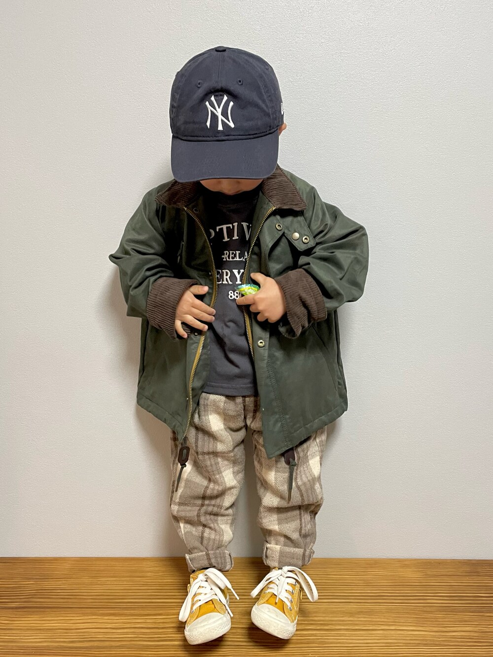 グリーン系のその他アウター、ホワイト系のTシャツ/カットソー、イエロー系のスニーカーを着用したキッズの春コーディネートの1枚目の写真
