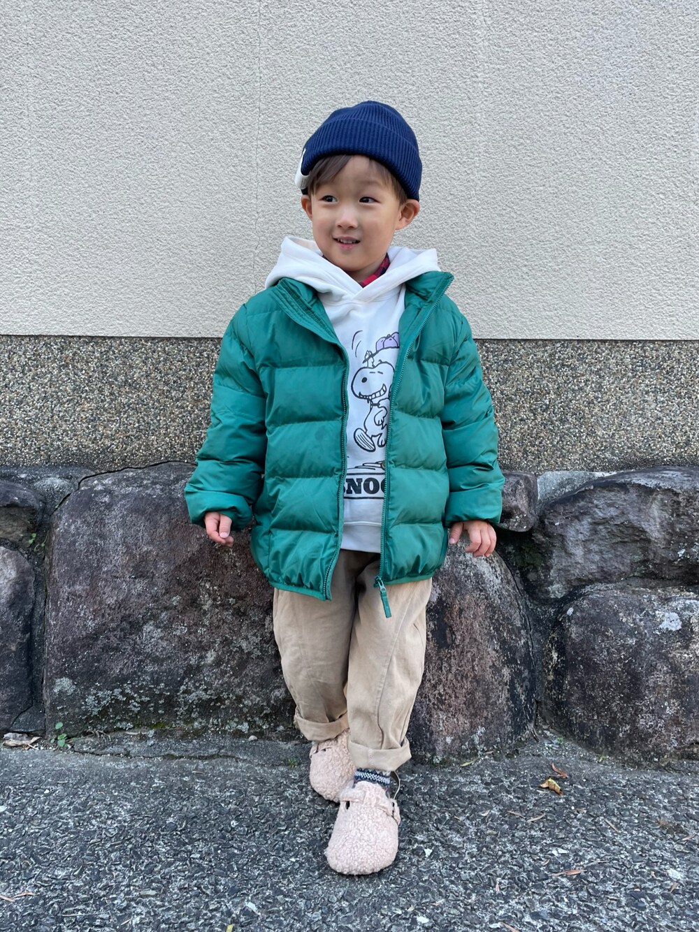 ホワイト系のパーカー、グリーン系のダウンジャケット/コート、ベージュ系のパンツを着用したキッズの冬コーディネートの1枚目の写真