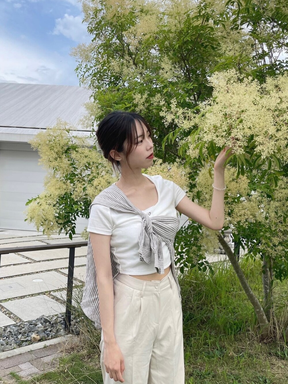 グレー系のシャツ/ブラウス、ベージュ系のスラックスを着用したレディースの秋コーディネートの1枚目の写真