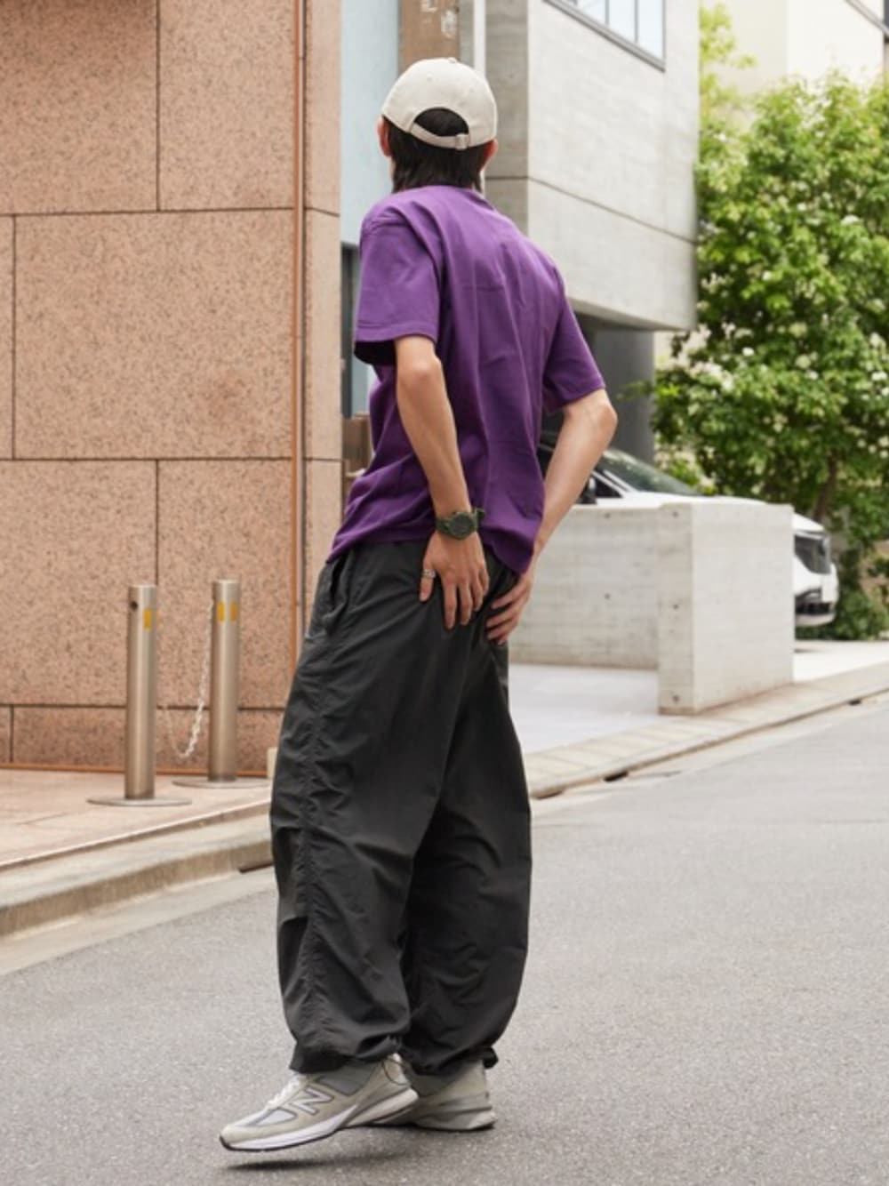 パープル系のTシャツ/カットソー、ブラック系のカーゴパンツ、ベージュ系のキャップを着用したメンズの夏コーディネートの1枚目の写真
