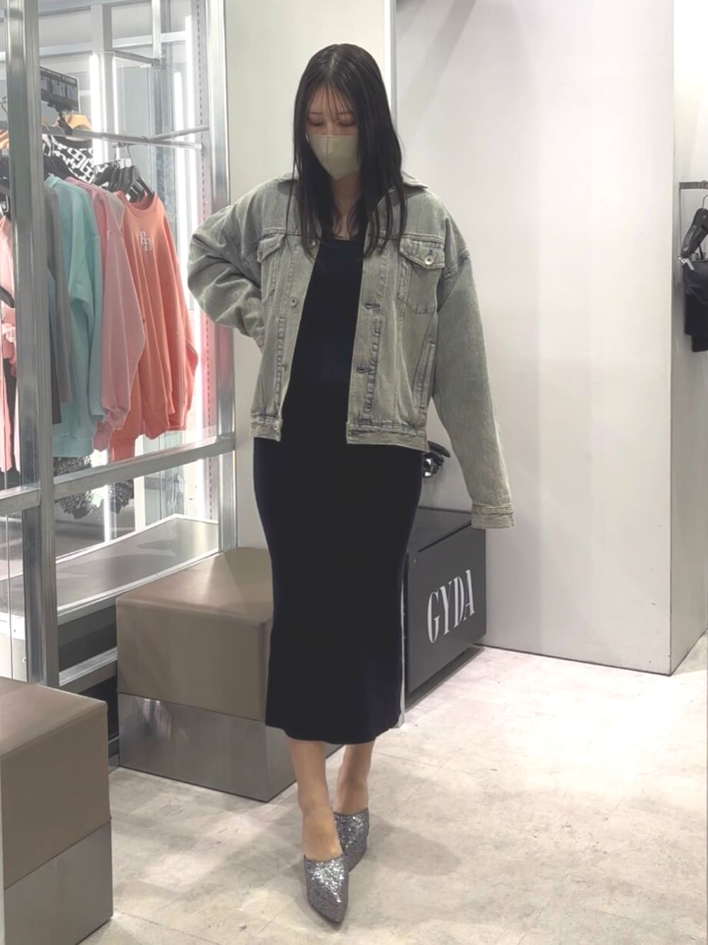 ブラック系のワンピース、ブルー系のデニムジャケット、グレー系のパンプスを着用したレディースの春コーディネートの1枚目の写真