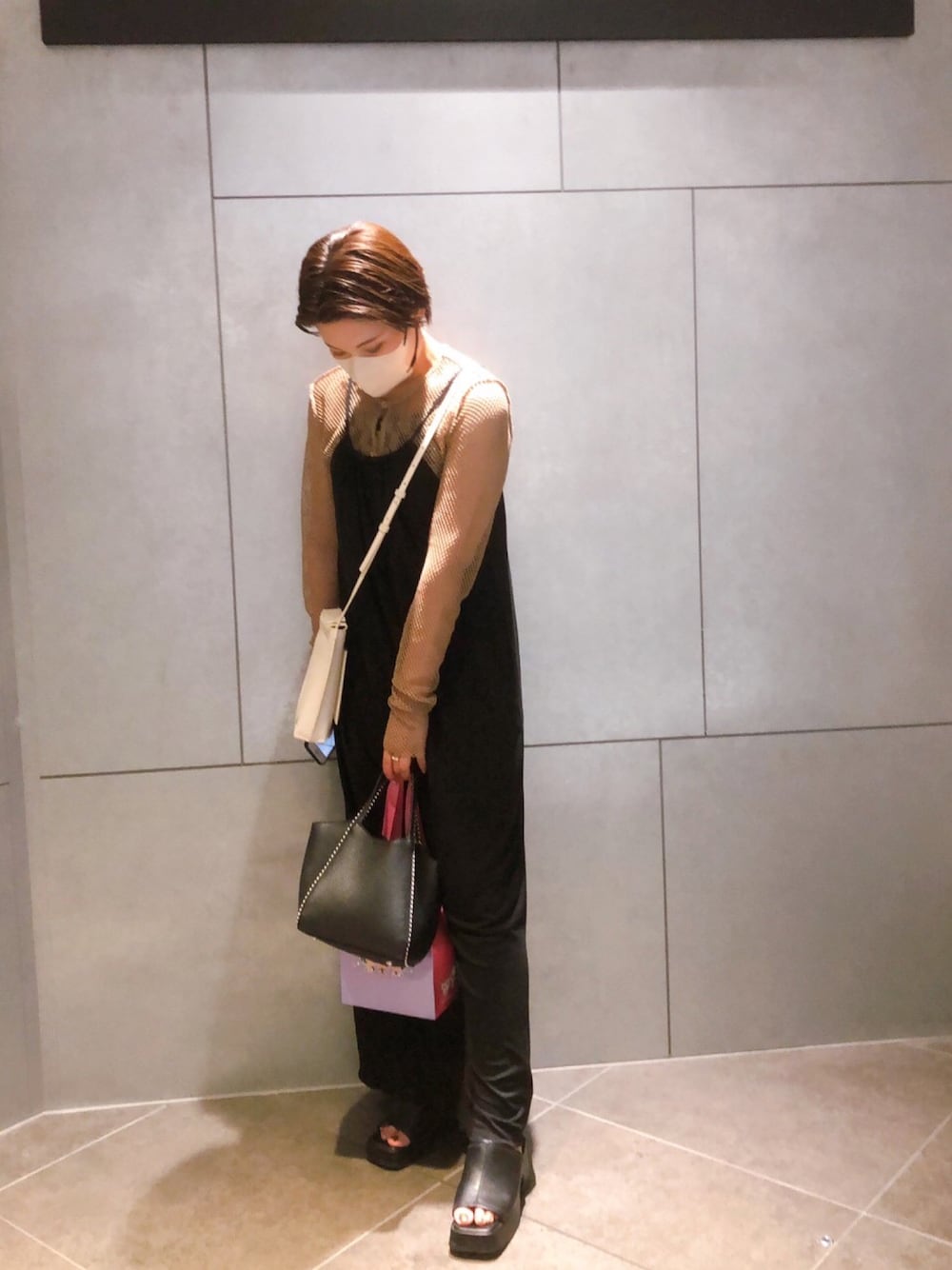 ブラック系のサンダル、ブラック系のワンピース、ブラック系のバッグを着用したレディースの夏コーディネートの1枚目の写真