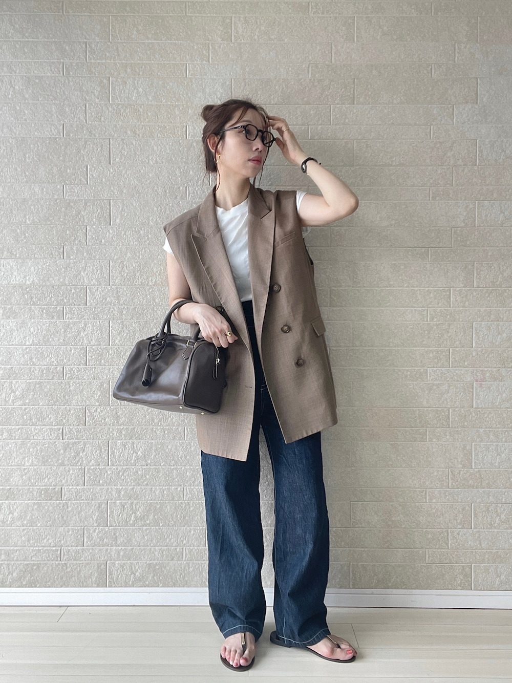 ブルー系のサロペット/オーバーオール、ブラウン系のベスト、ブラウン系のボストンバッグを着用したレディースの夏コーディネートの1枚目の写真