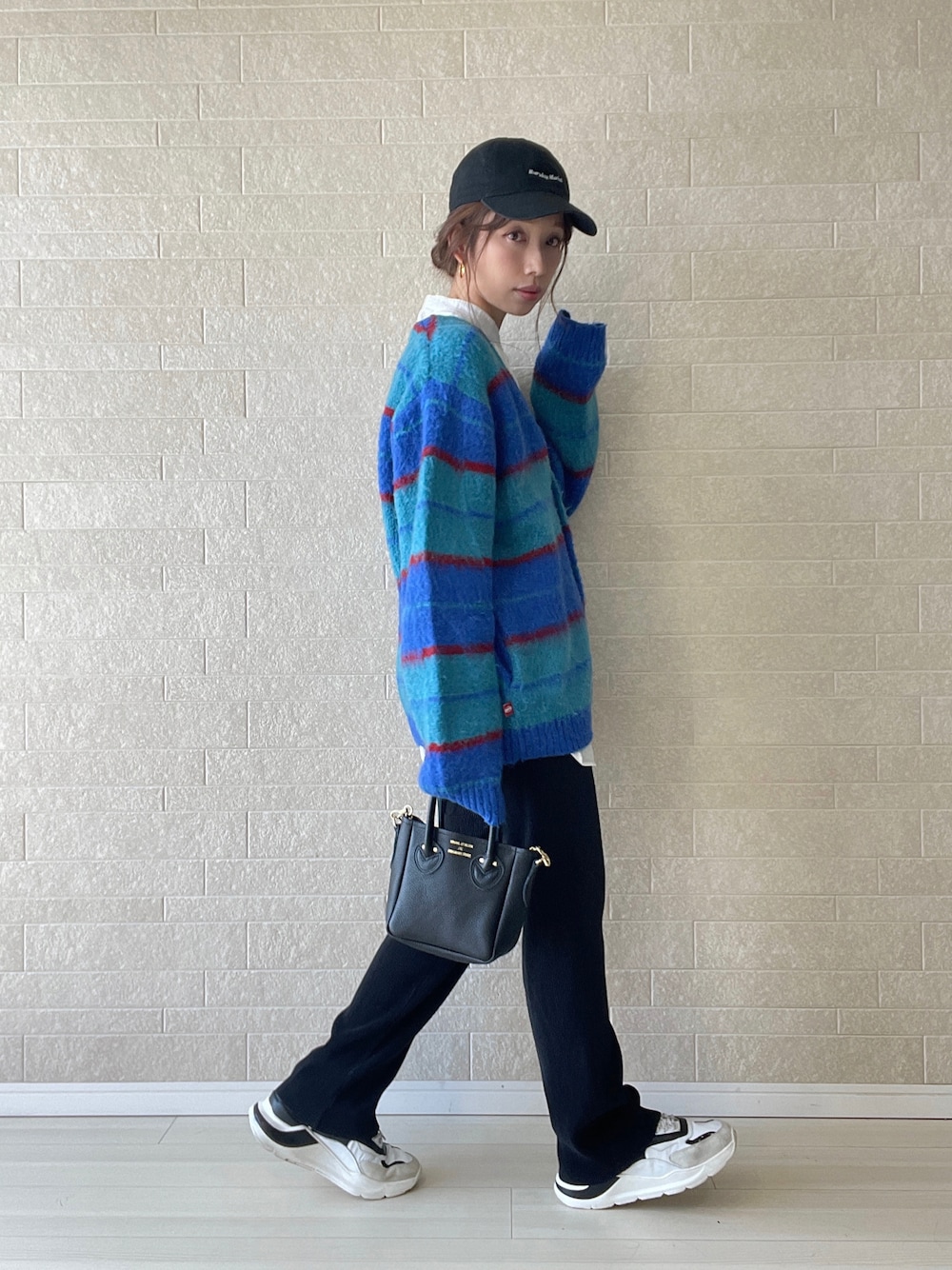 ブラック系のその他パンツ、ブラック系のトートバッグ、ホワイト系のスニーカーを着用したレディースの秋コーディネートの1枚目の写真