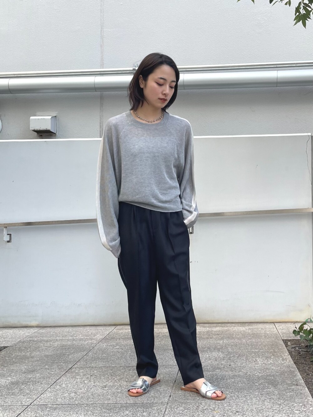 ブラック系のその他パンツ、グレー系のニット/セーターを着用したレディースの春コーディネートの1枚目の写真