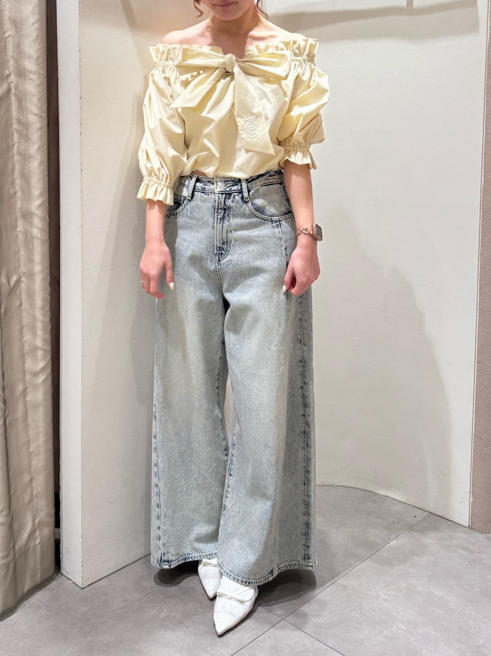 ブルー系のデニムパンツ、ホワイト系のパンプス、イエロー系のシャツ/ブラウスを着用したレディースの春コーディネートの1枚目の写真