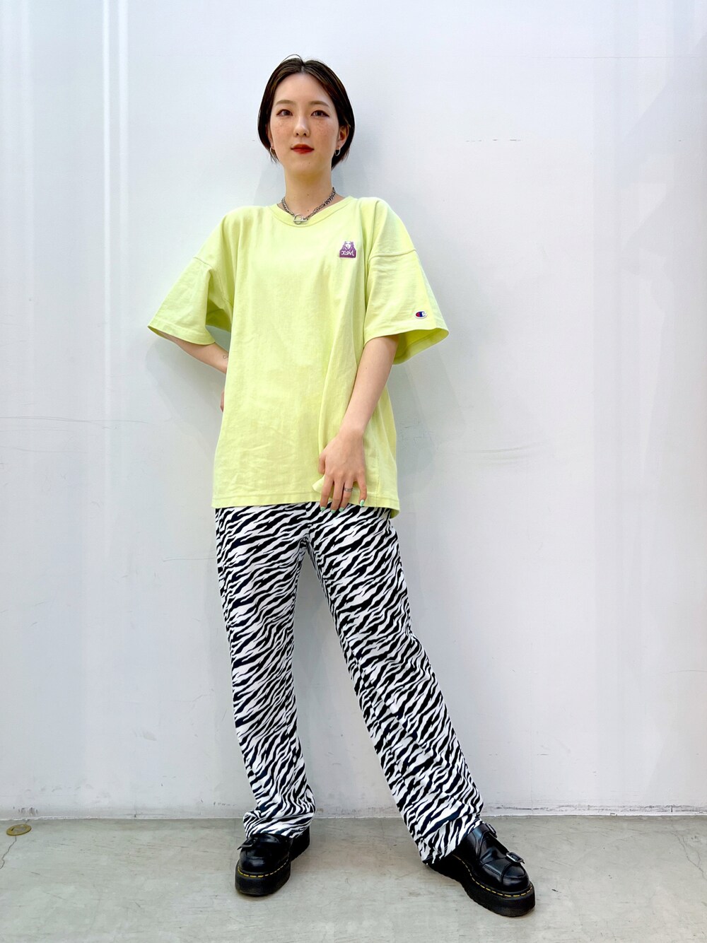 ホワイト系のその他パンツ、グリーン系のTシャツ/カットソー、シルバー系のネックレスを着用したレディースの春コーディネートの1枚目の写真