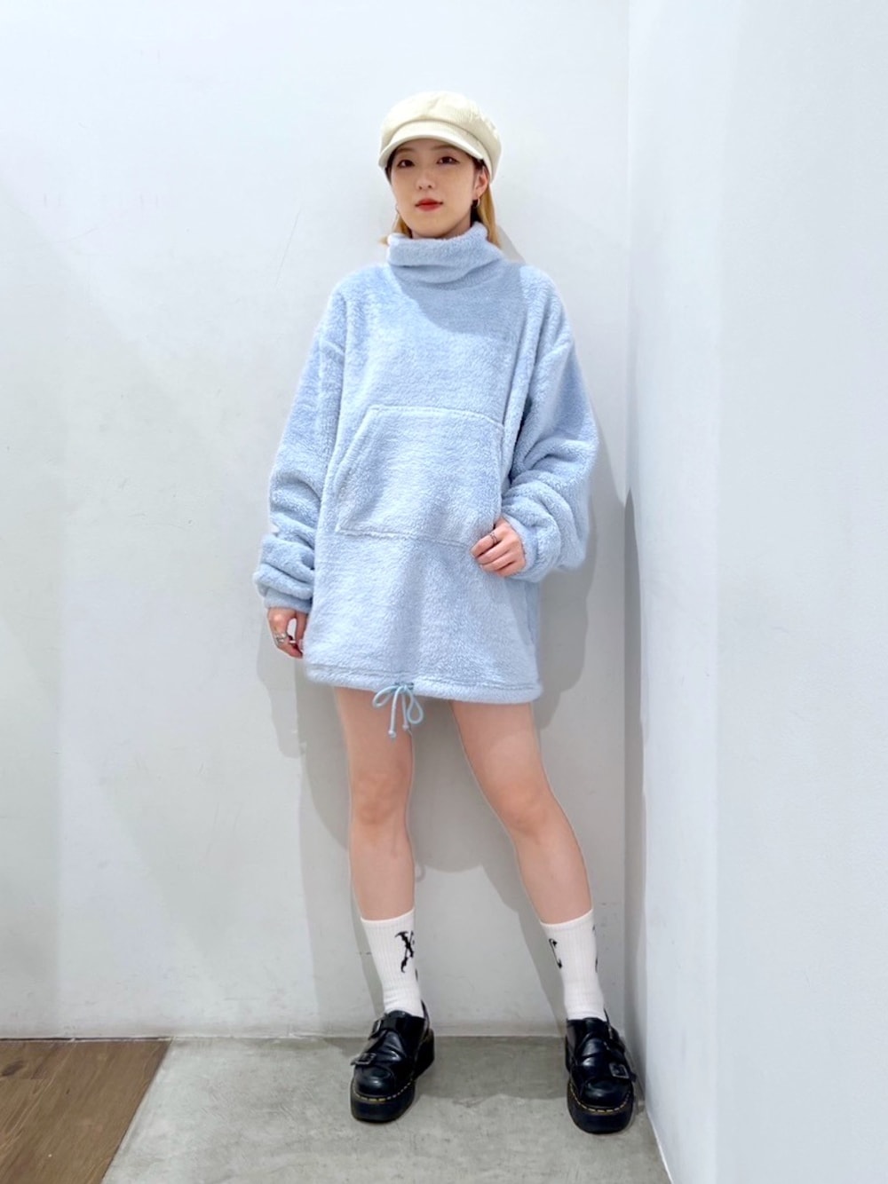 ブルー系のチュニック、ホワイト系のキャスケット、ホワイト系のソックス/靴下を着用したレディースの秋コーディネートの1枚目の写真