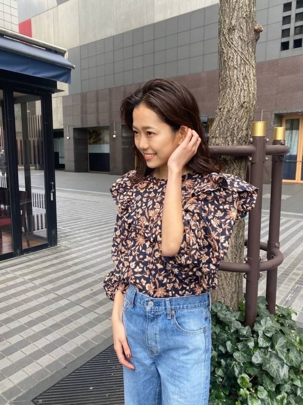 ブルー系のデニムパンツ、ブルー系のシャツ/ブラウス、ホワイト系のサンダルを着用したレディースの春コーディネートの1枚目の写真