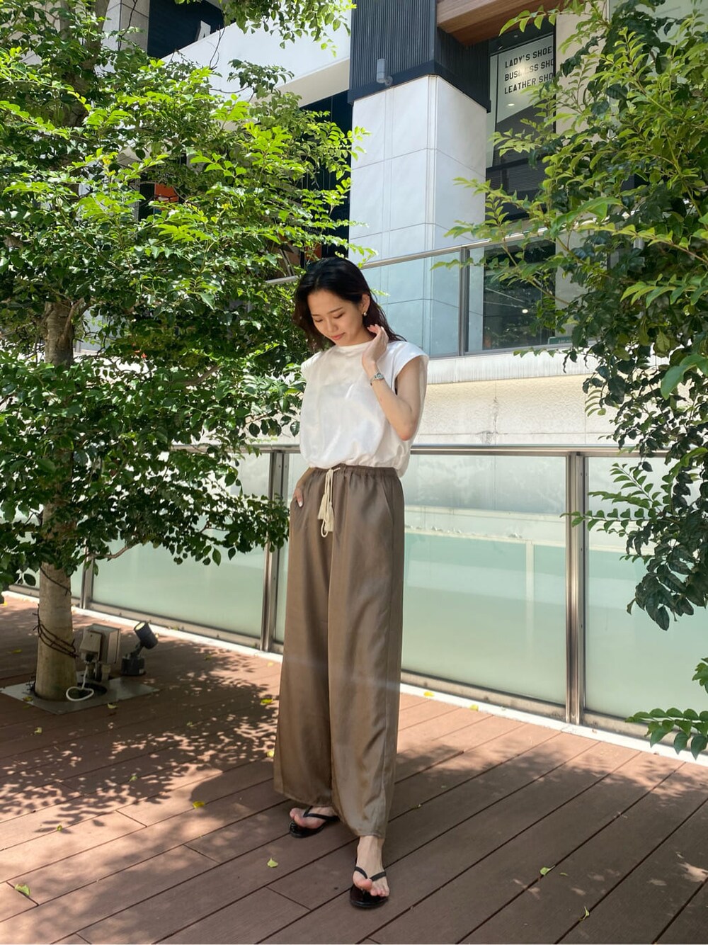 ブラウン系のその他パンツ、ホワイト系のTシャツ/カットソーを着用したレディースの春コーディネートの1枚目の写真