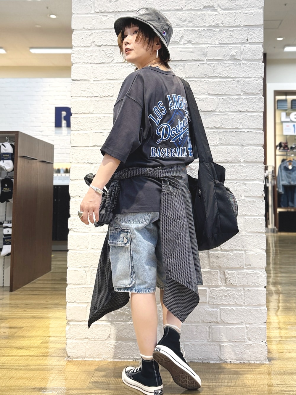 ブラック系のTシャツ/カットソー、ブルー系のその他パンツ、ブラック系のハットを着用したレディースの春コーディネートの1枚目の写真