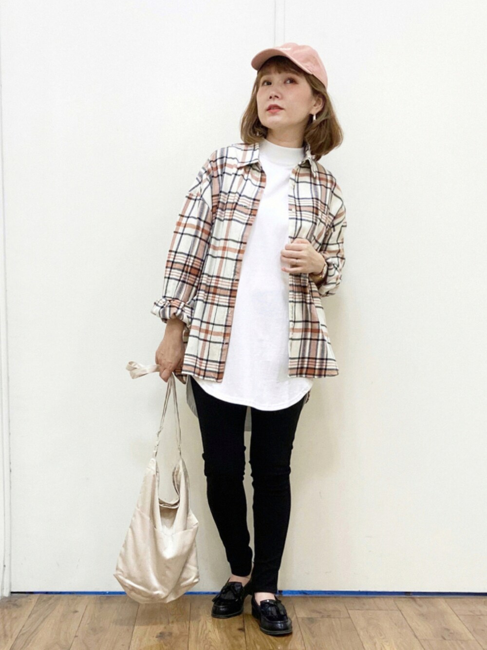 ベージュ系のショルダーバッグ、ブラック系のローファー、ホワイト系のTシャツ/カットソーを着用したレディースの夏コーディネートの1枚目の写真