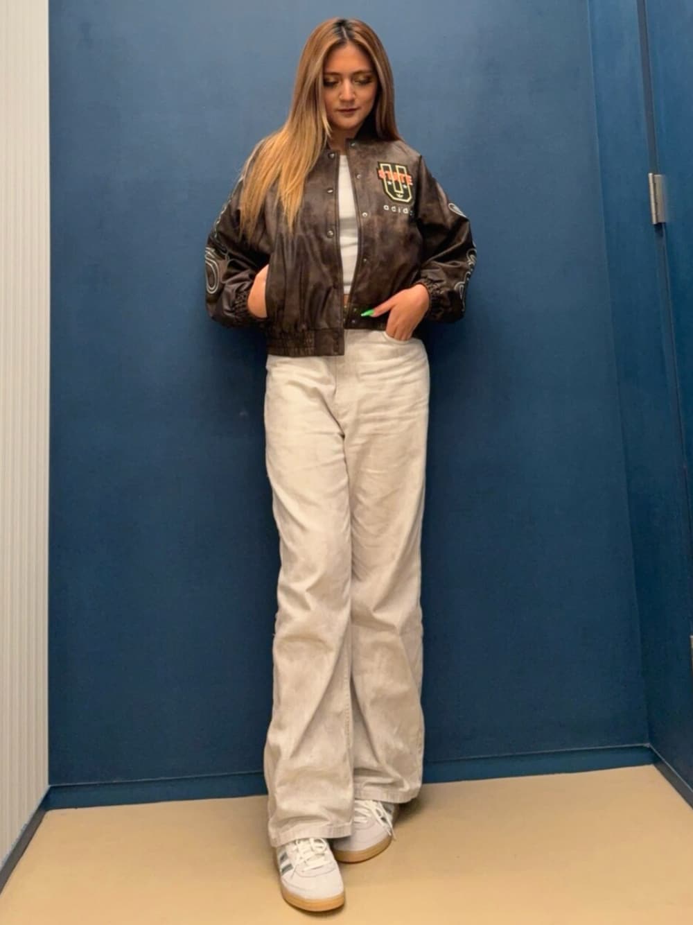 グレー系のスニーカー、ブラウン系のジャケット/アウターを着用したレディースの秋コーディネートの1枚目の写真