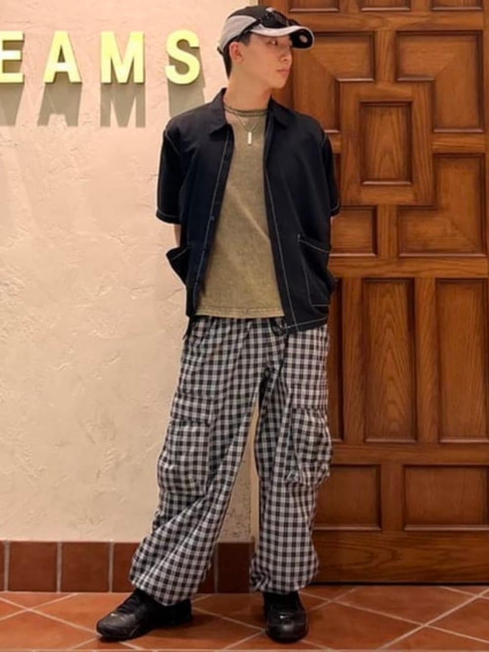 ブラック系のカーゴパンツ、ブラック系のシャツ/ブラウス、イエロー系のTシャツ/カットソーを着用したメンズの夏コーディネートの1枚目の写真