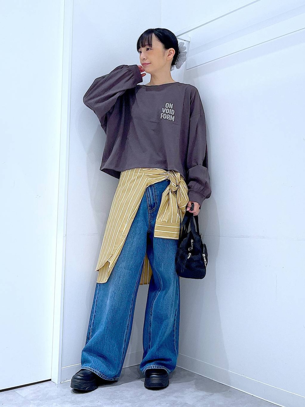 ブルー系のデニムパンツ、イエロー系のシャツ/ブラウス、グレー系のTシャツ/カットソーを着用したレディースの秋コーディネートの1枚目の写真