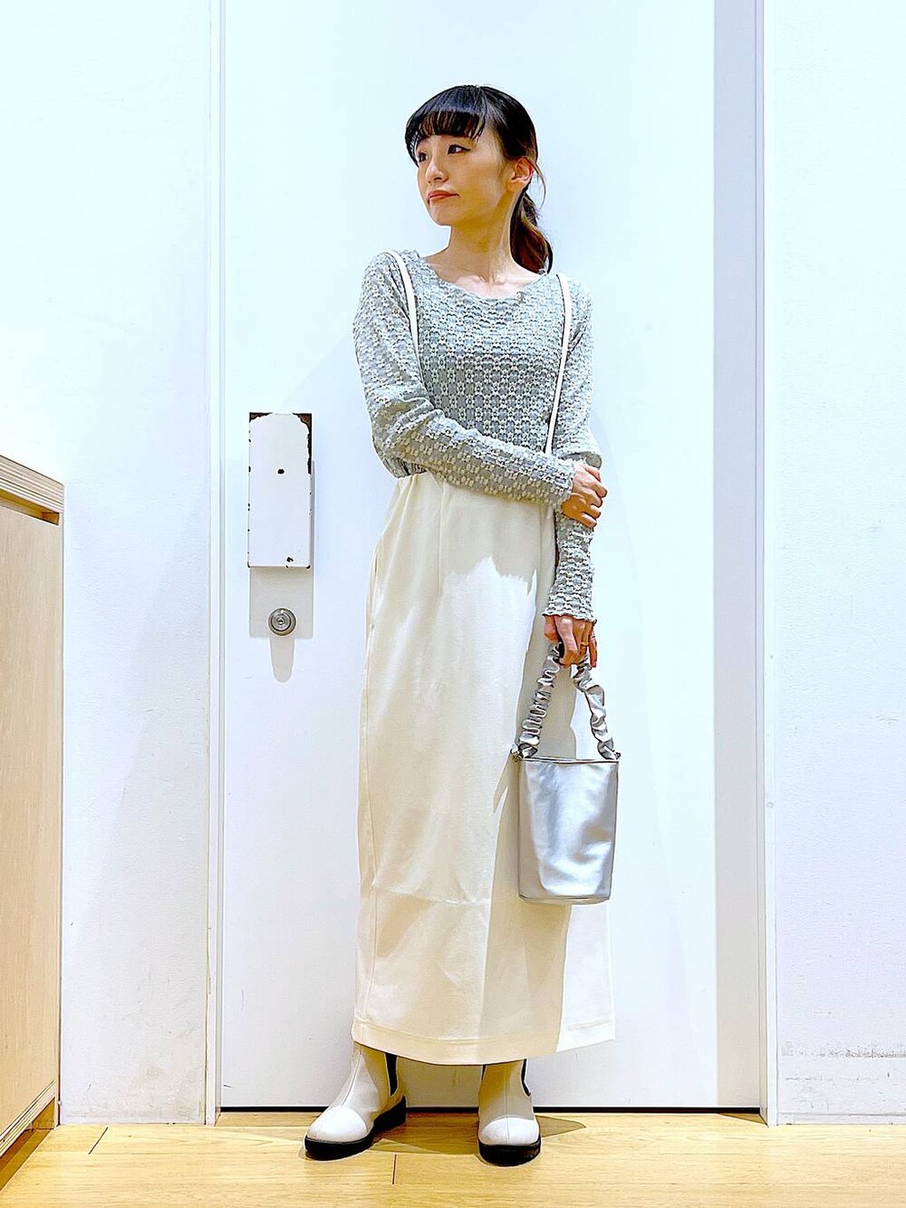 その他のショルダーバッグ、ベージュ系のブーツ、ホワイト系のスカートを着用したレディースの春コーディネートの1枚目の写真