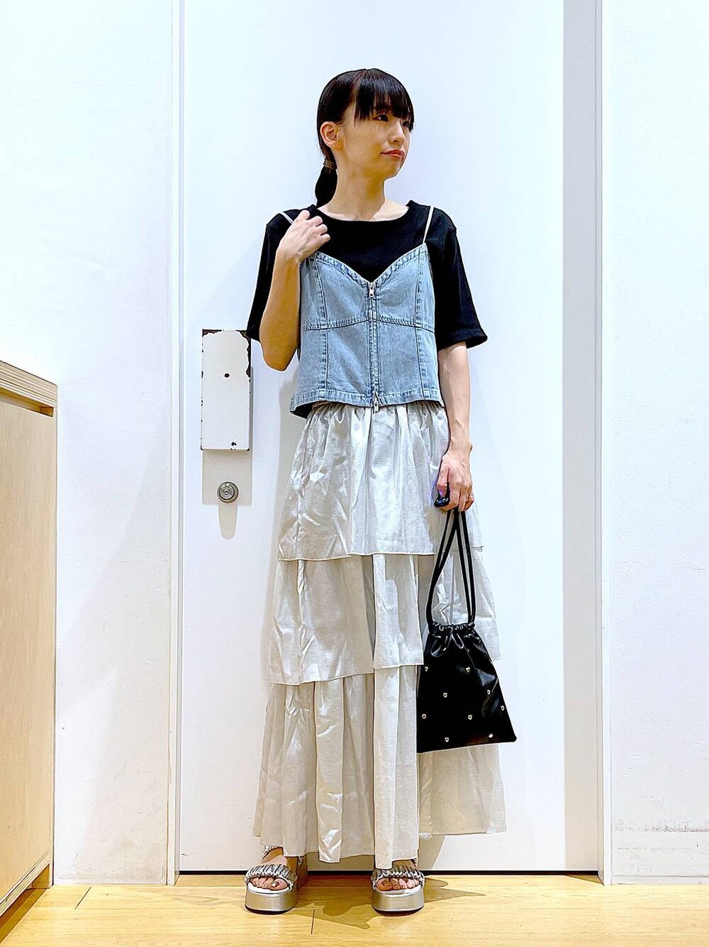 シルバー系のサンダル、ブラック系のショルダーバッグ、ブラック系のTシャツ/カットソーを着用したレディースの夏コーディネートの1枚目の写真