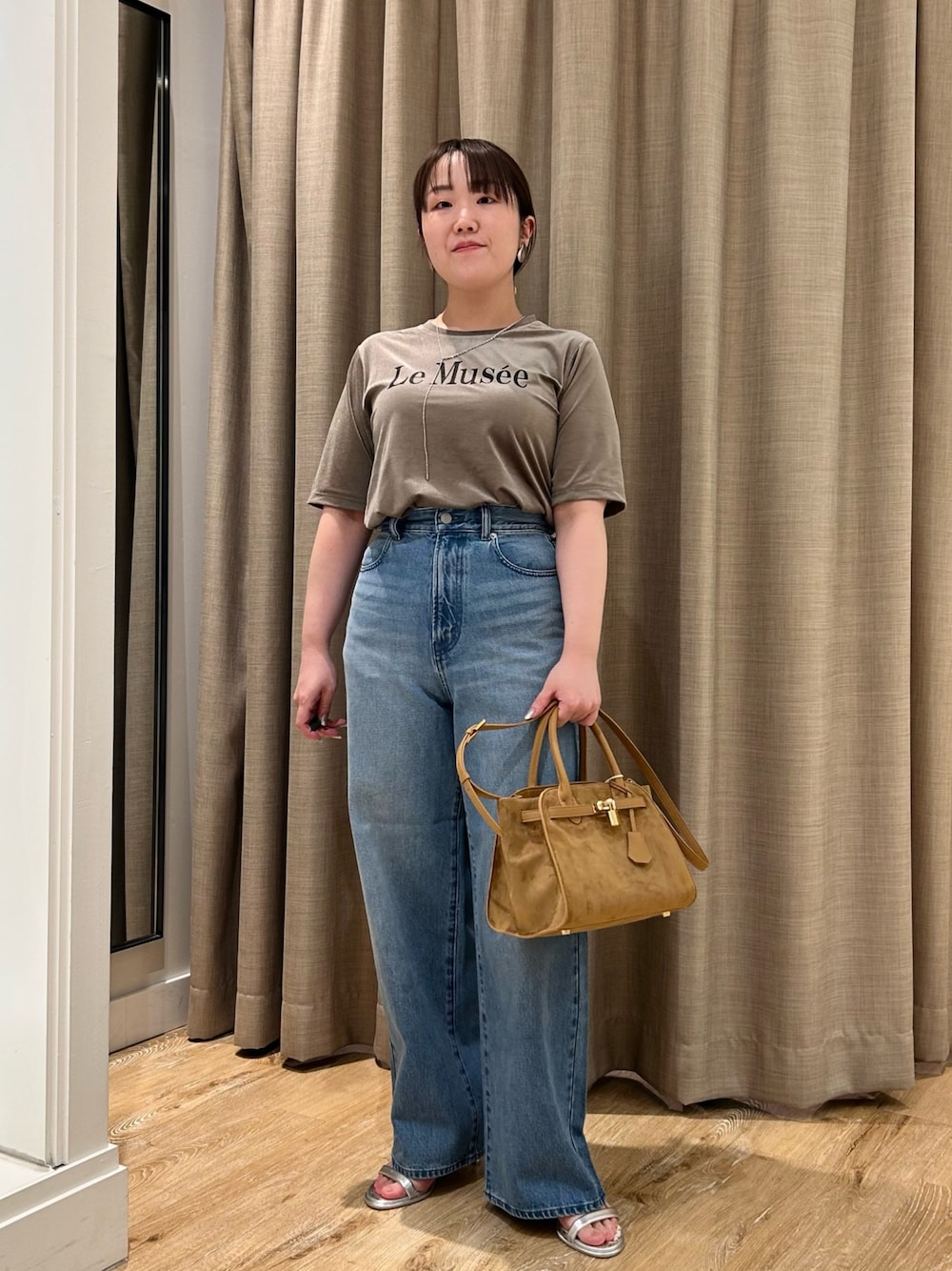 グリーン系のTシャツ/カットソー、ブルー系のデニムパンツ、イエロー系のトートバッグを着用したレディースの秋コーディネートの1枚目の写真