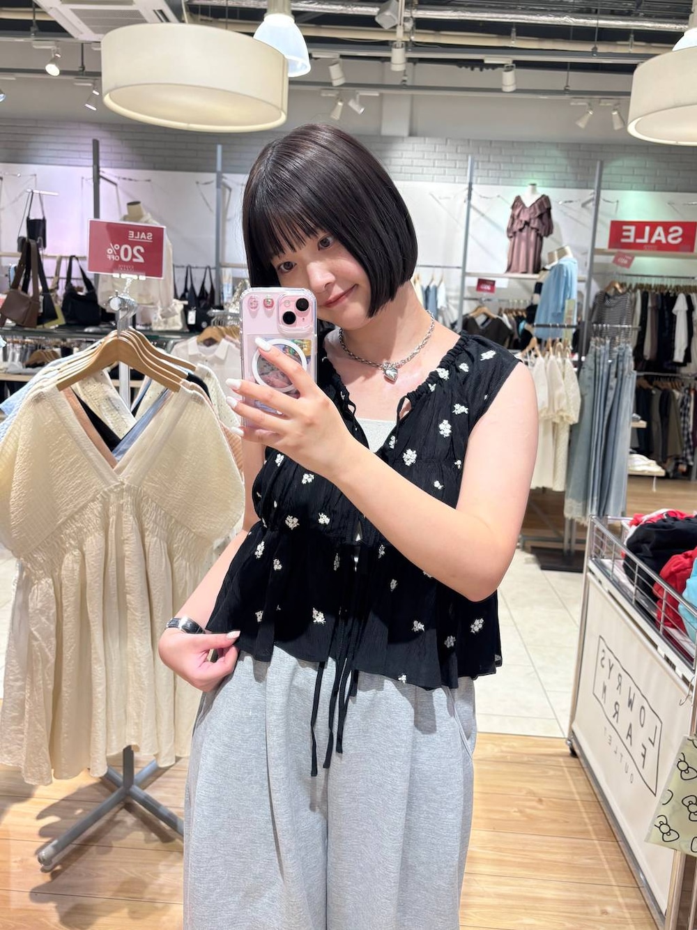 グレー系のスウェットパンツ、シルバー系のタンクトップ、ブラック系のサンダルを着用したレディースの夏コーディネートの1枚目の写真
