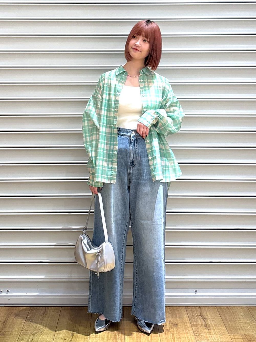 グリーン系のシャツ/ブラウス、シルバー系のトートバッグ、ホワイト系のタンクトップを着用したレディースの春コーディネートの1枚目の写真