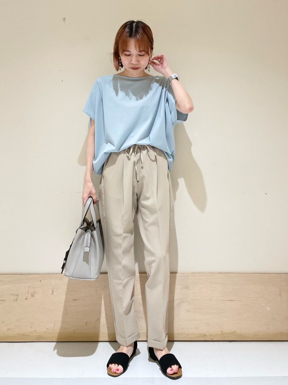 ベージュ系のその他パンツ、ブルー系のTシャツ/カットソー、ブラック系のサンダルを着用したレディースの夏コーディネートの1枚目の写真