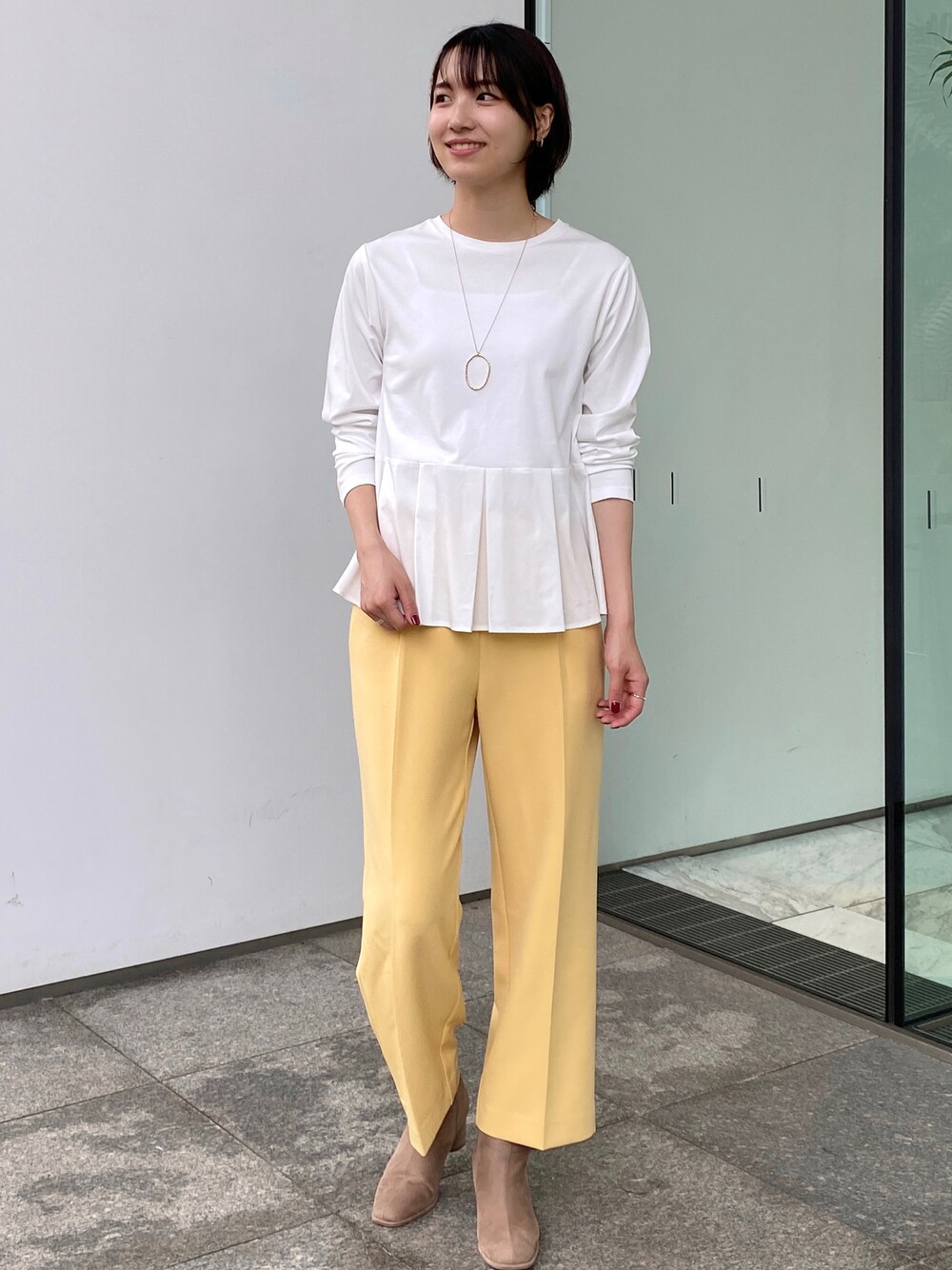 ホワイト系のTシャツ/カットソー、イエロー系のその他パンツ、ゴールド系のネックレスを着用したレディースの秋コーディネートの1枚目の写真