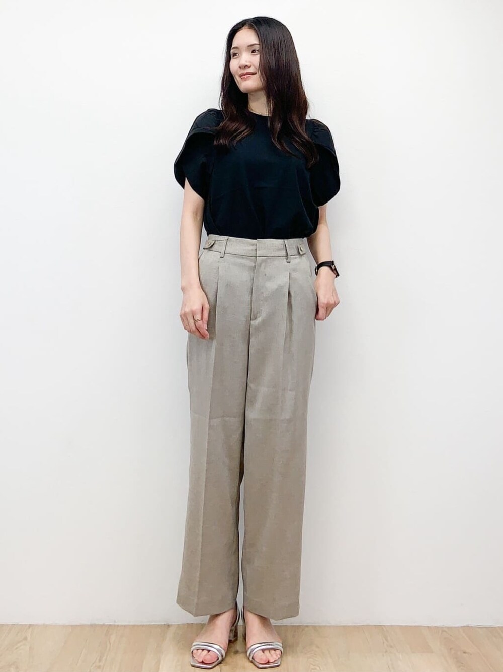 ブラック系のTシャツ/カットソー、ベージュ系のその他パンツ、シルバー系のサンダルを着用したレディースの春コーディネートの1枚目の写真