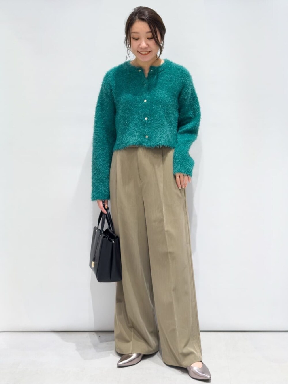 グリーン系のカーディガン/ボレロ、ブラウン系のその他パンツ、ブラック系のトートバッグを着用したレディースの秋コーディネートの1枚目の写真