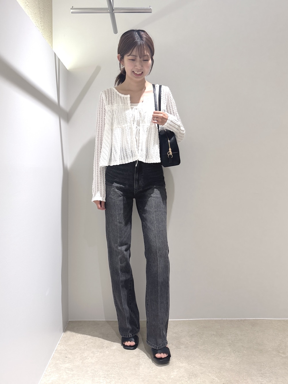 ホワイト系のカーディガン/ボレロ、ブラック系のその他パンツ、ブラック系のボストンバッグを着用したレディースの夏コーディネートの1枚目の写真
