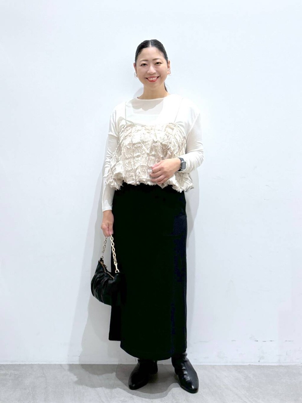 ブラック系のスカート、ブラック系のスカート、ホワイト系のTシャツ/カットソーを着用したレディースの秋コーディネートの1枚目の写真