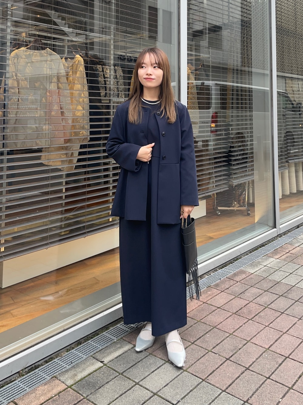 ブルー系のノーカラージャケット、ブルー系のワンピース、シルバー系のパンプスを着用したレディースの冬コーディネートの1枚目の写真