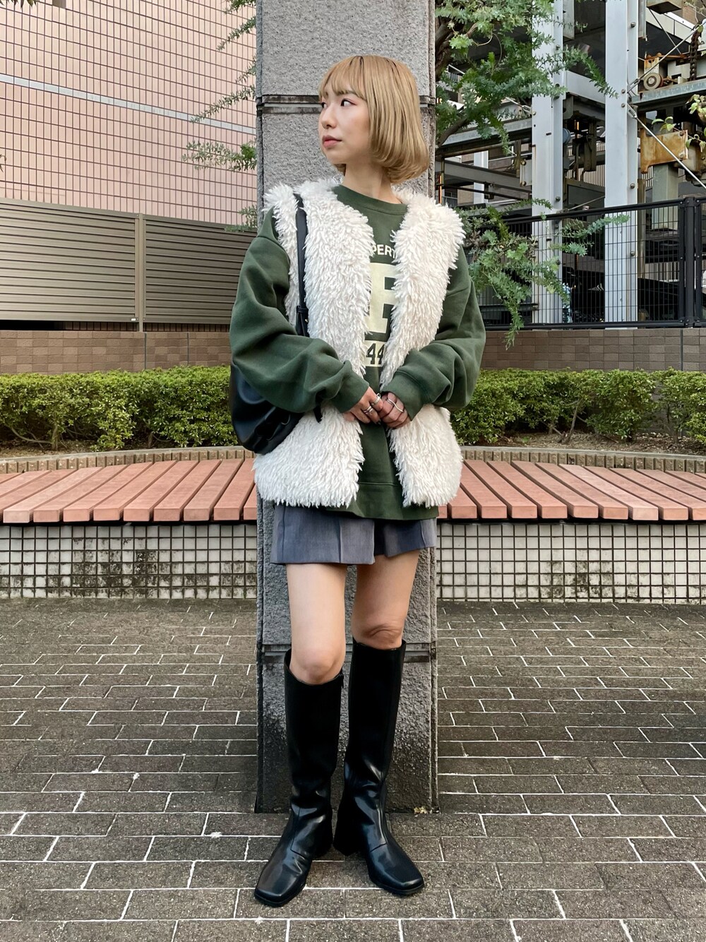 ホワイト系のベスト、グレー系のその他パンツ、グリーン系のスウェットを着用したレディースの秋コーディネートの1枚目の写真