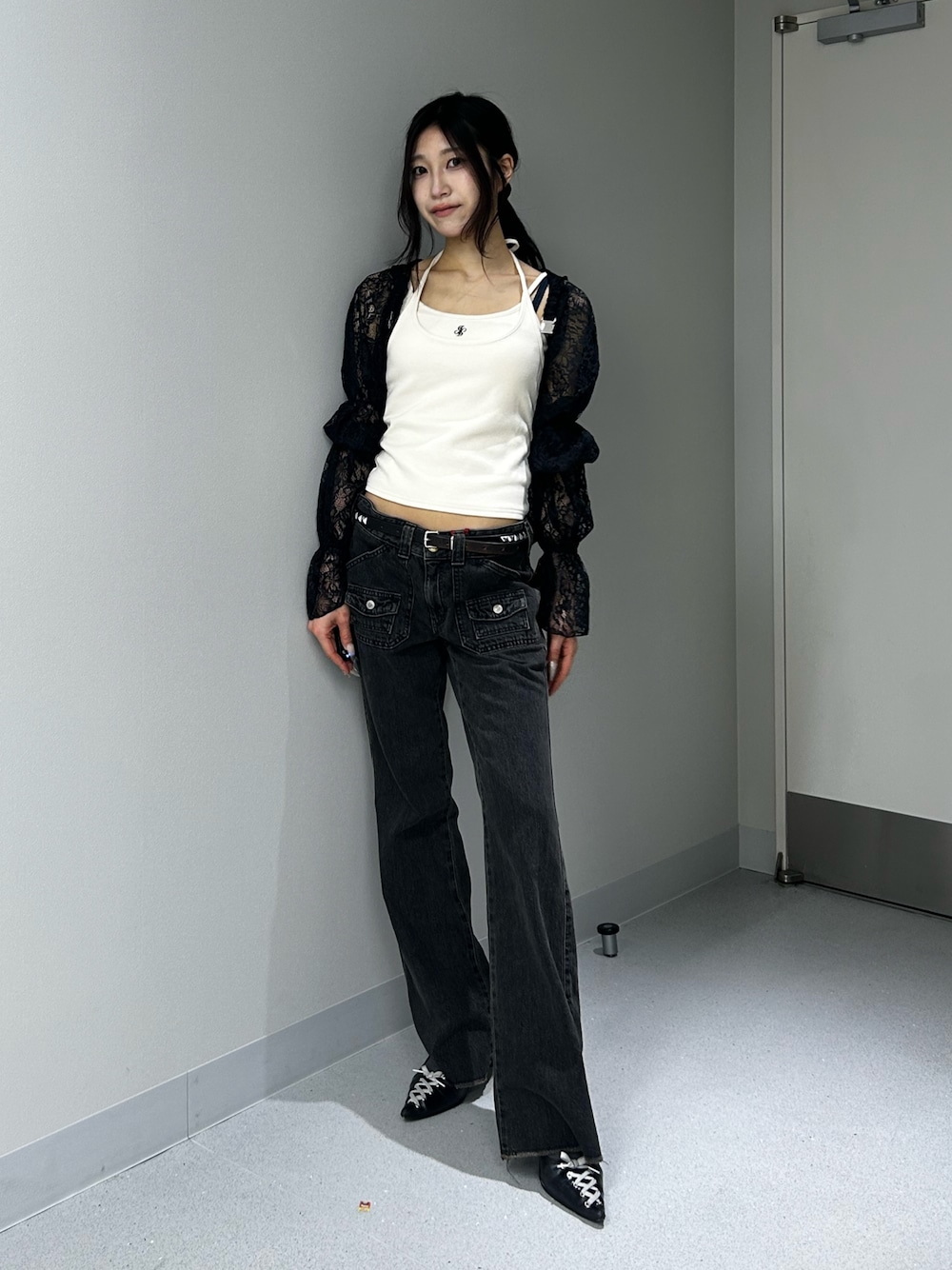 ブラック系のデニムパンツ、ホワイト系のキャミソール、ブラック系のカーディガン/ボレロを着用したレディースの夏コーディネートの1枚目の写真