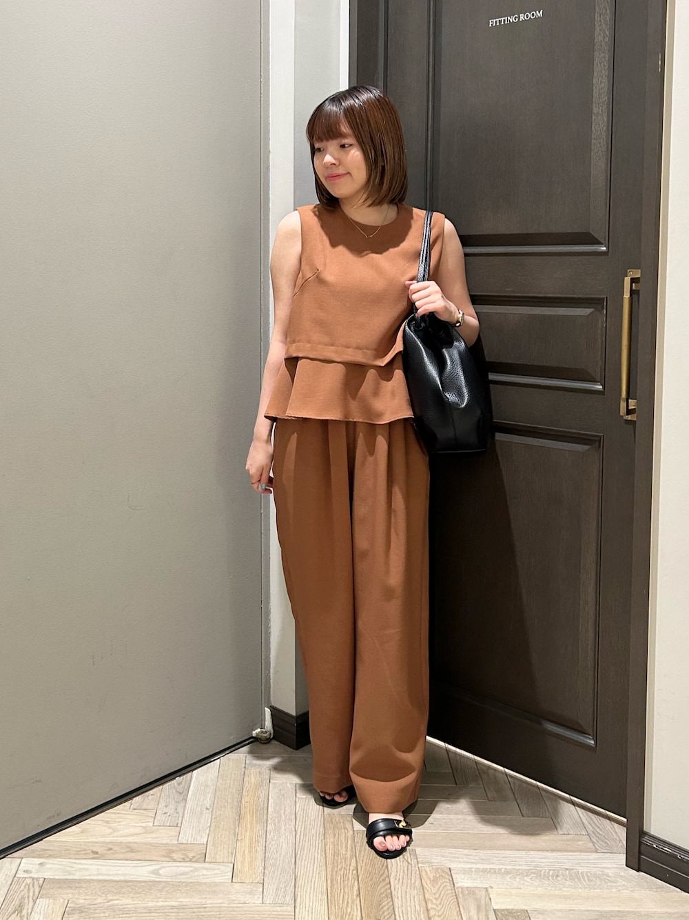 イエロー系のシャツ/ブラウス、イエロー系のその他パンツ、ブラック系のトートバッグを着用したレディースの秋コーディネートの1枚目の写真