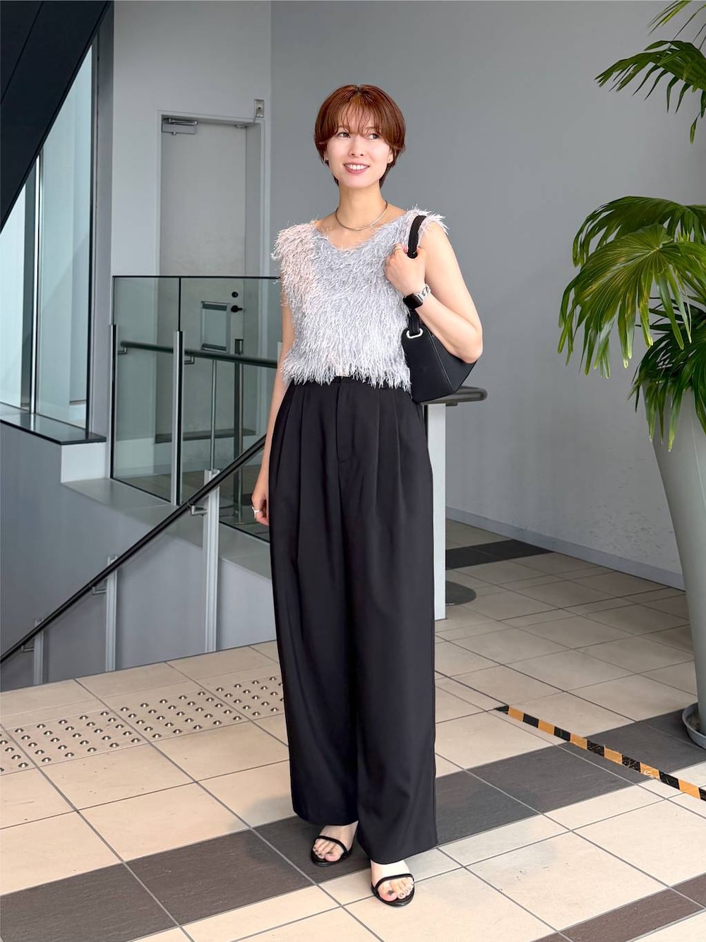 グレー系のベスト、ブラック系のその他パンツ、ブラック系のショルダーバッグを着用したレディースの夏コーディネートの1枚目の写真