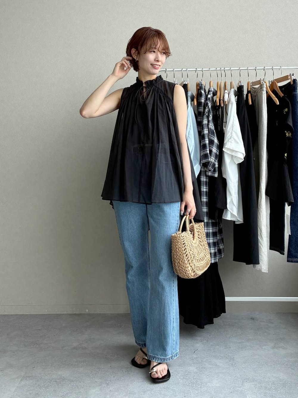 ブラック系のシャツ/ブラウス、ブルー系のデニムパンツ、ベージュ系のかごバッグを着用したレディースの夏コーディネートの1枚目の写真