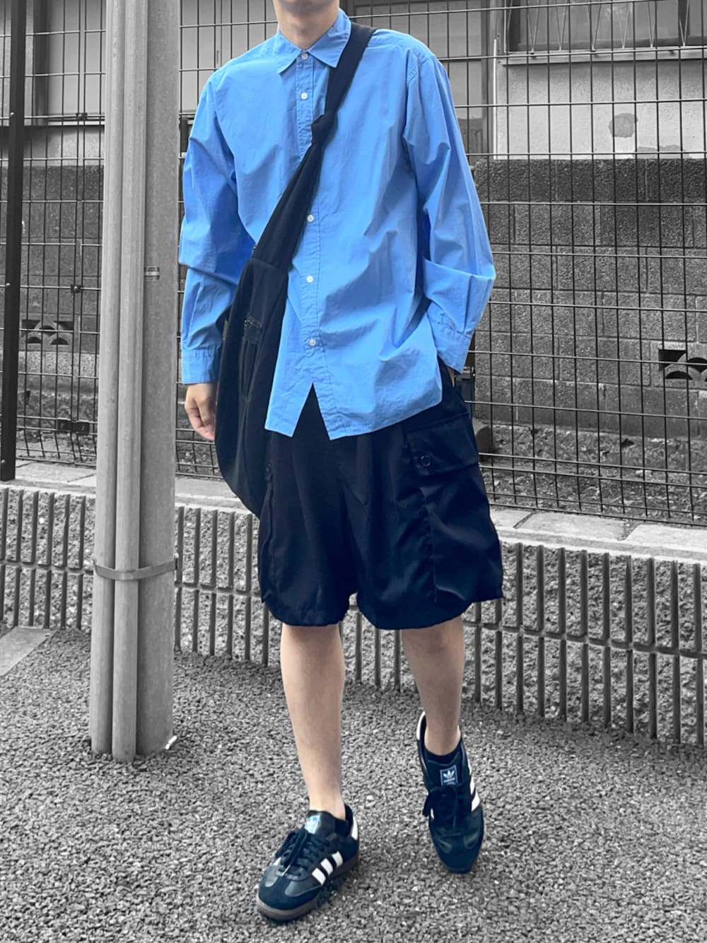 ブラック系のスニーカー、ブルー系のシャツ/ブラウス、ブラック系のショルダーバッグを着用したメンズの春コーディネートの1枚目の写真