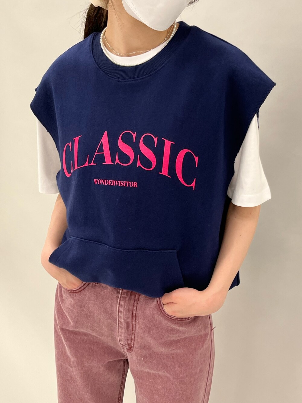 ブルー系のベスト、レッド系のデニムパンツを着用したレディースの春コーディネートの3枚目の写真