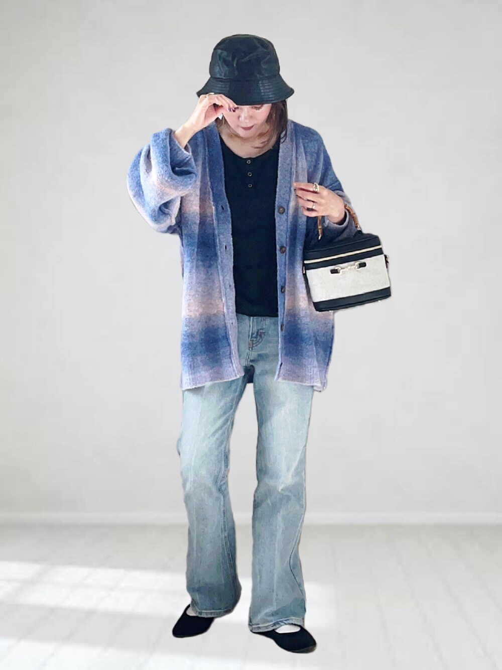 ブルー系のカーディガン/ボレロ、ブルー系のデニムパンツ、ブラック系のタンクトップを着用したレディースの秋コーディネートの1枚目の写真