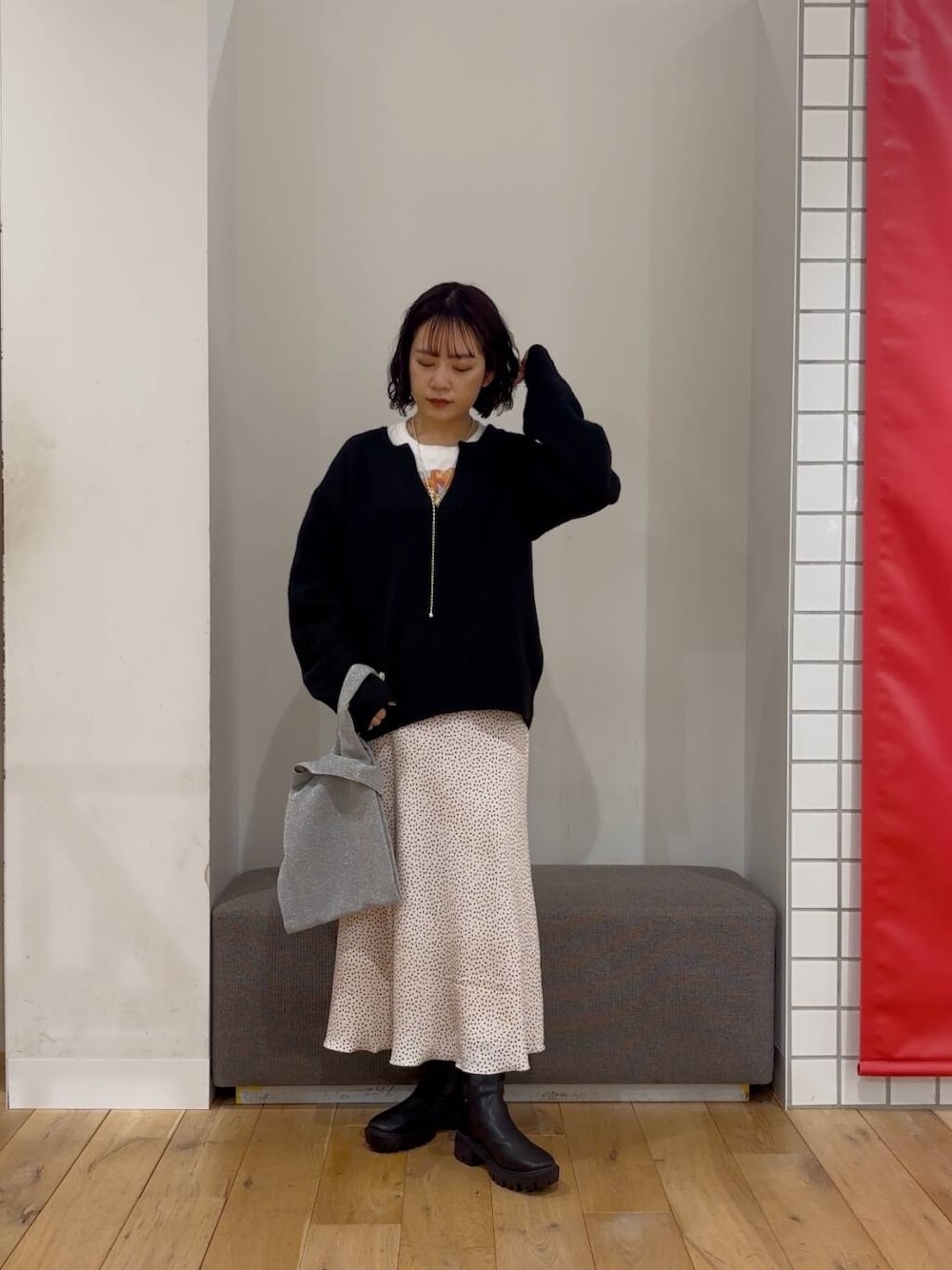 シルバー系のトートバッグ、ブラック系のブーツ、その他のTシャツ/カットソーを着用したレディースの冬コーディネートの1枚目の写真