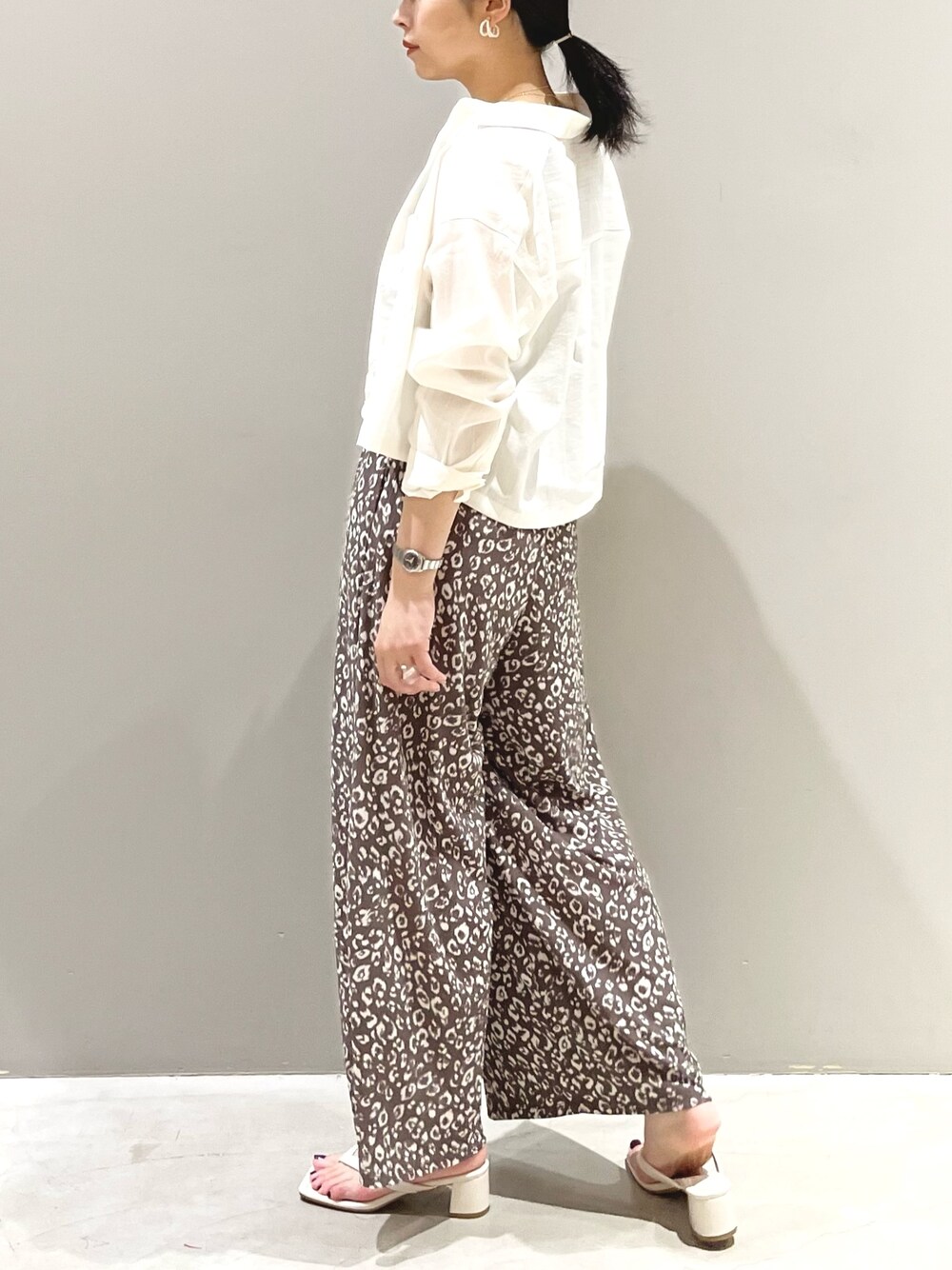 ホワイト系のサンダル、ホワイト系のシャツ/ブラウス、ブラック系のタンクトップを着用したレディースの夏コーディネートの3枚目の写真